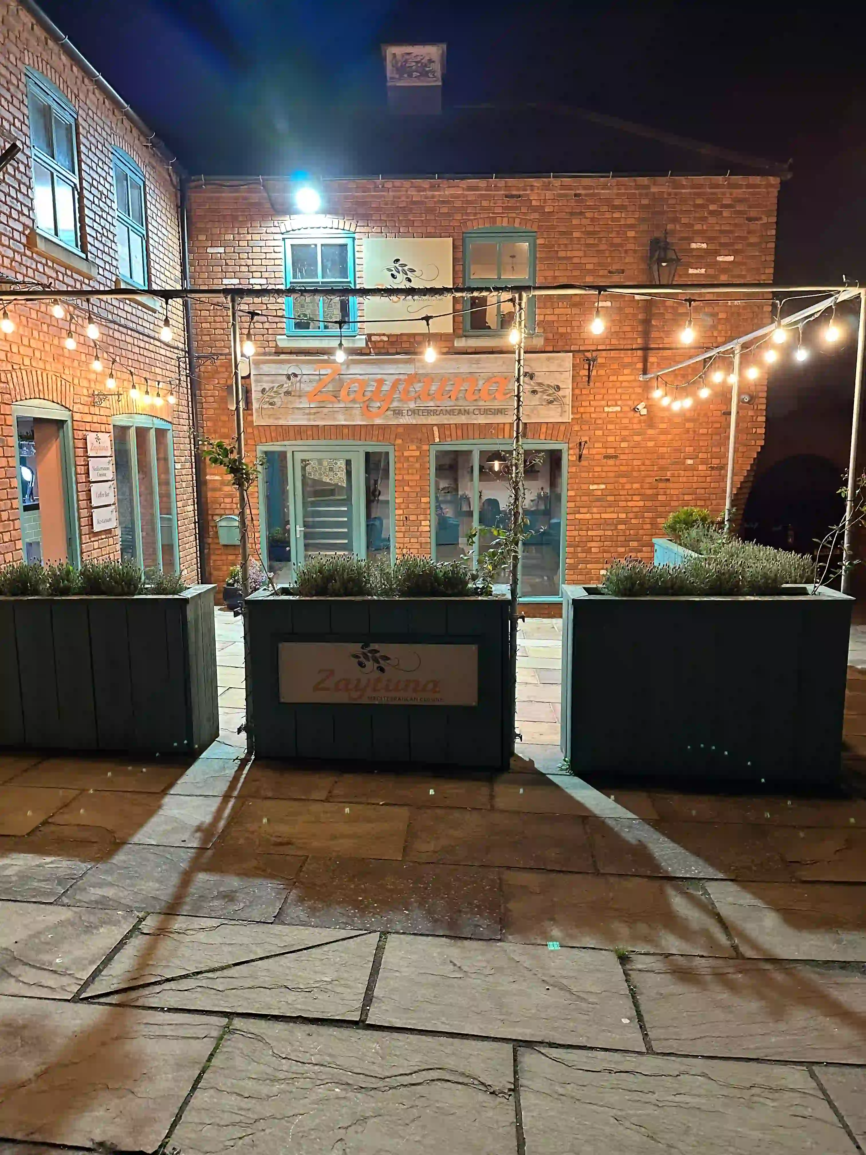 Our restaurant's facade at night, looking from straight ahead